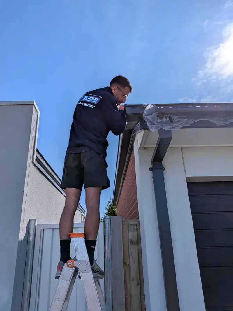 Roof plumber working on gutter in Glen Iris